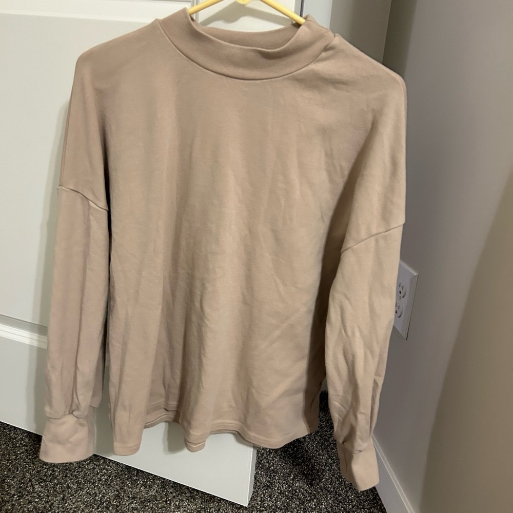 Tan long sleeve turtleneck.